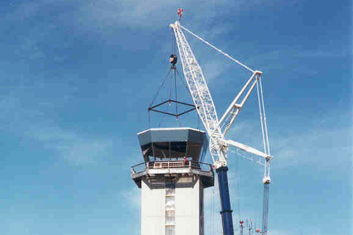 The control cab rigged and hoisted into position on the tower