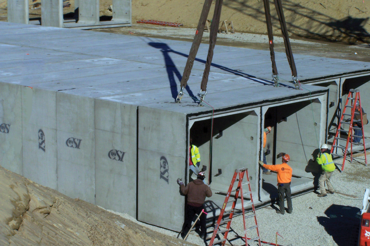 Placing one of the concrete units of the holding tank that is 400-feet long, 50-feet-wide and are buried 20 feet below ground