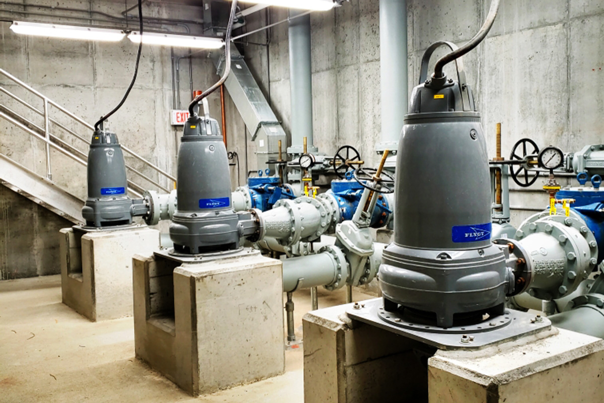 Three dry-pit submersible pumps with suction and discharge piping