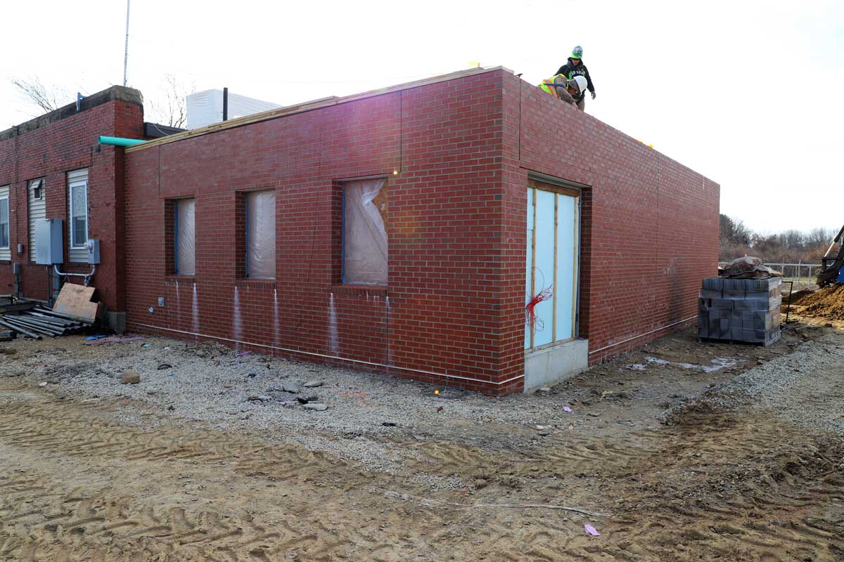 Finishing the roof on the new pump station with the old pump station next to it