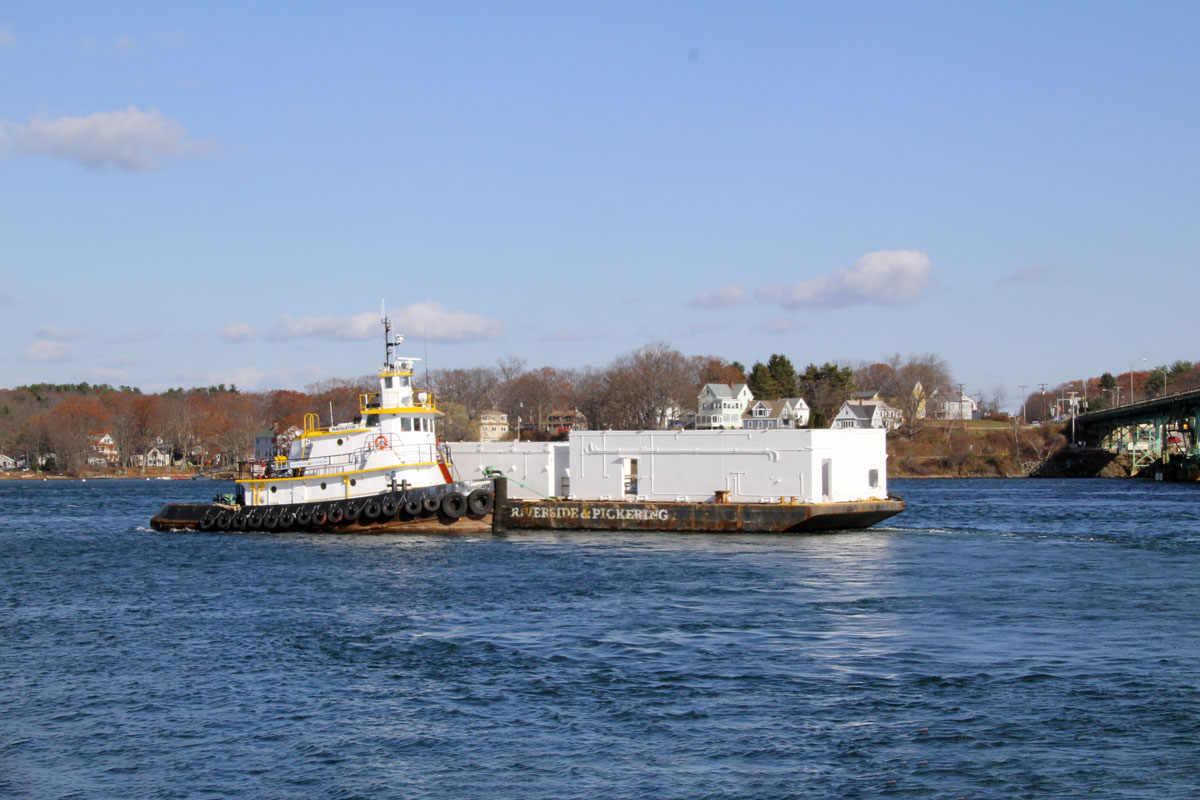Transporting the modular unit via tugboat and barge to the Portsmouth Naval Shipyard