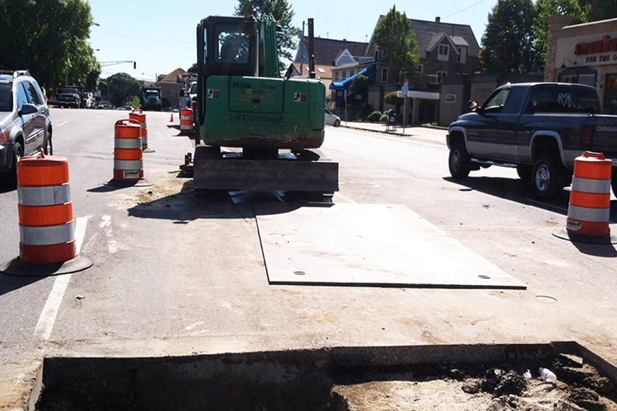 Preparing to finish covering the sewer catch basin