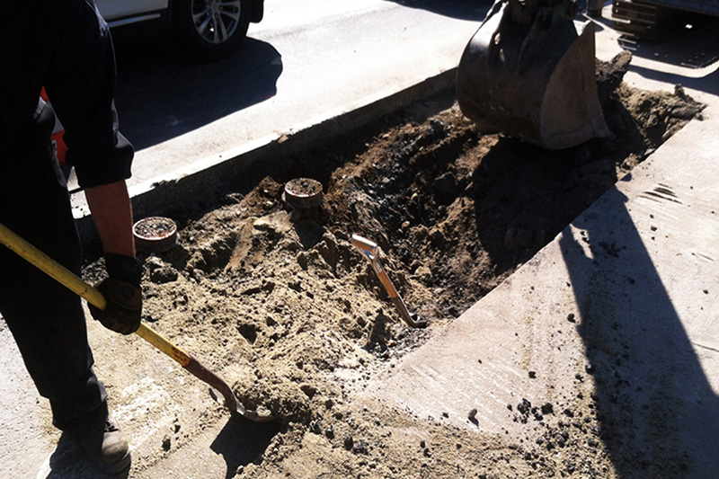 Opening the catch basin with the backhoe