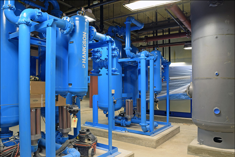 Air compressor room with air dryers (blue) and air receiver